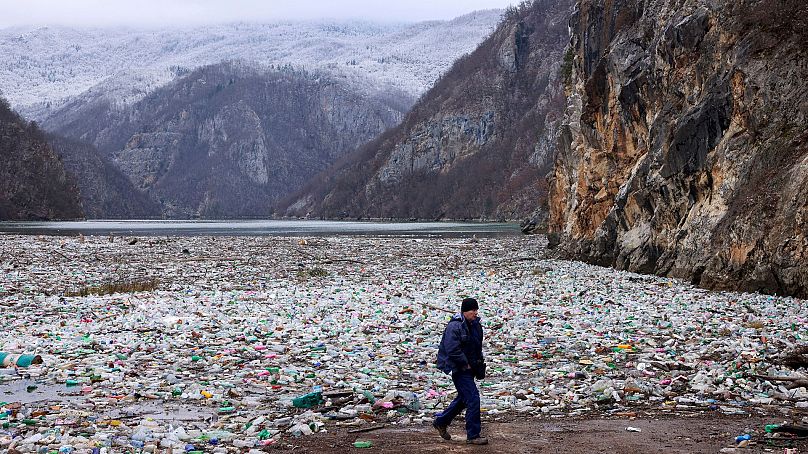 A crane operator walks next to the waste footing in the Drina river near Visegrad, Bosnia, 10 January 2024.