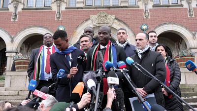 South Africa's Minister of Justice Ronald Lamola, centre, and Palestinian assistant Minister of Multilateral Affairs Ammar Hijazi, third right, address the press in The Hague.