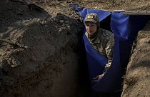 A Ukrainian serviceman exits a bunker on the outskirts of Kyiv, Ukraine, Sunday, March 20, 2022