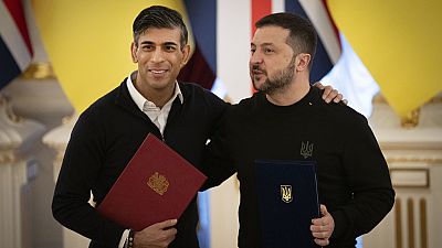Britain's Prime Minister Rishi Sunak, left, hugs Ukrainian President Volodymyr Zelenskyy after signing documents in Kyiv, Ukraine on Friday