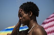 A man cools off in a shower at Ipanema beach, Rio de Janeiro, Brazil in September