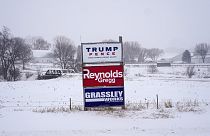 Campaign signs are seen during a winter storm in Sioux City, Iowa
