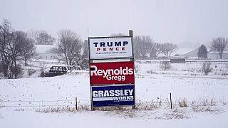 Campaign signs are seen during a winter storm in Sioux City, Iowa