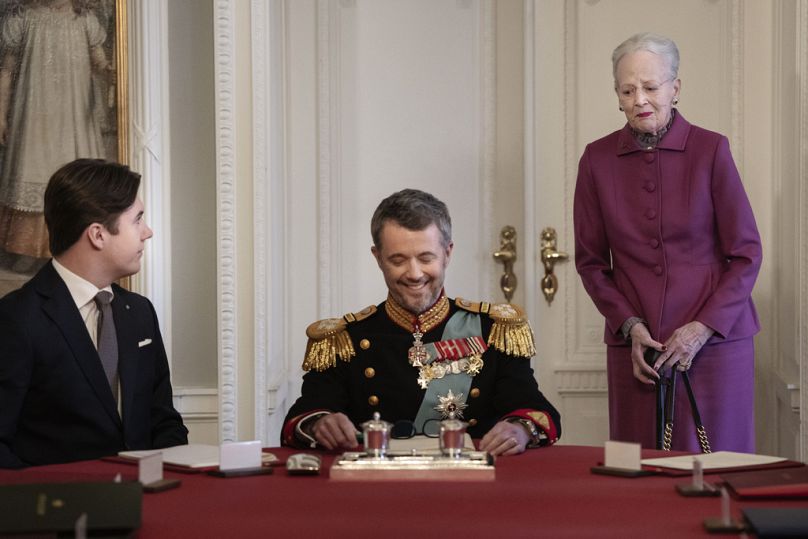 Denmark's King Frederik X takes a seat at the head of the table after Queen Margrethe II signed a declaration of abdication in a meeting of the Council of State in Copenhagen