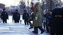 Wives of Russian soldiers mobilized for fighting in Ukraine walk to lay flowers at the Unknown Soldier's Tomb at the Kremlin wall in Moscow, Russia, Saturday, Jan. 13, 2024.