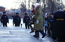 Wives of Russian soldiers mobilized for fighting in Ukraine walk to lay flowers at the Unknown Soldier's Tomb at the Kremlin wall in Moscow, Russia, Saturday, Jan. 13, 2024.