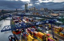 A container is loaded onto a cargo ship in the harbor in Frankfurt, Germany, Wednesday, Dec. 13, 2023. 