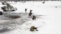 In this handout photo from a video released by Russian Defense Ministry Press Service on Dec. 28, 2022, Russian soldiers take part in drills at an unspecified location.