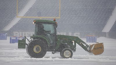 Workers remove snow from Highmark Stadium in Orchard Park, N.Y., Sunday Jan. 14, 2024