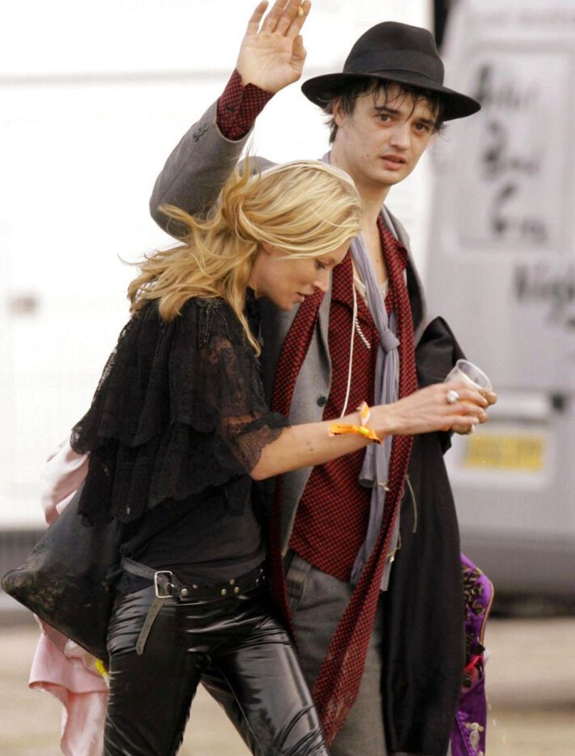 Pete Doherty waves as he walks with Moss at the 2007 Glastonbury Festival in Pilton, England Saturday June 23, 2007.