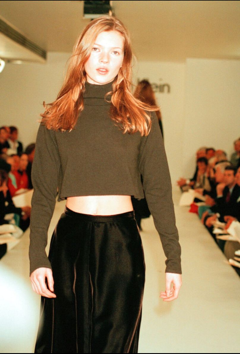 Kate Moss wears a bare midriff outfit from Calvin Klein's Fall 1993 collection on the designer's runway in New York on 1 June 1993.