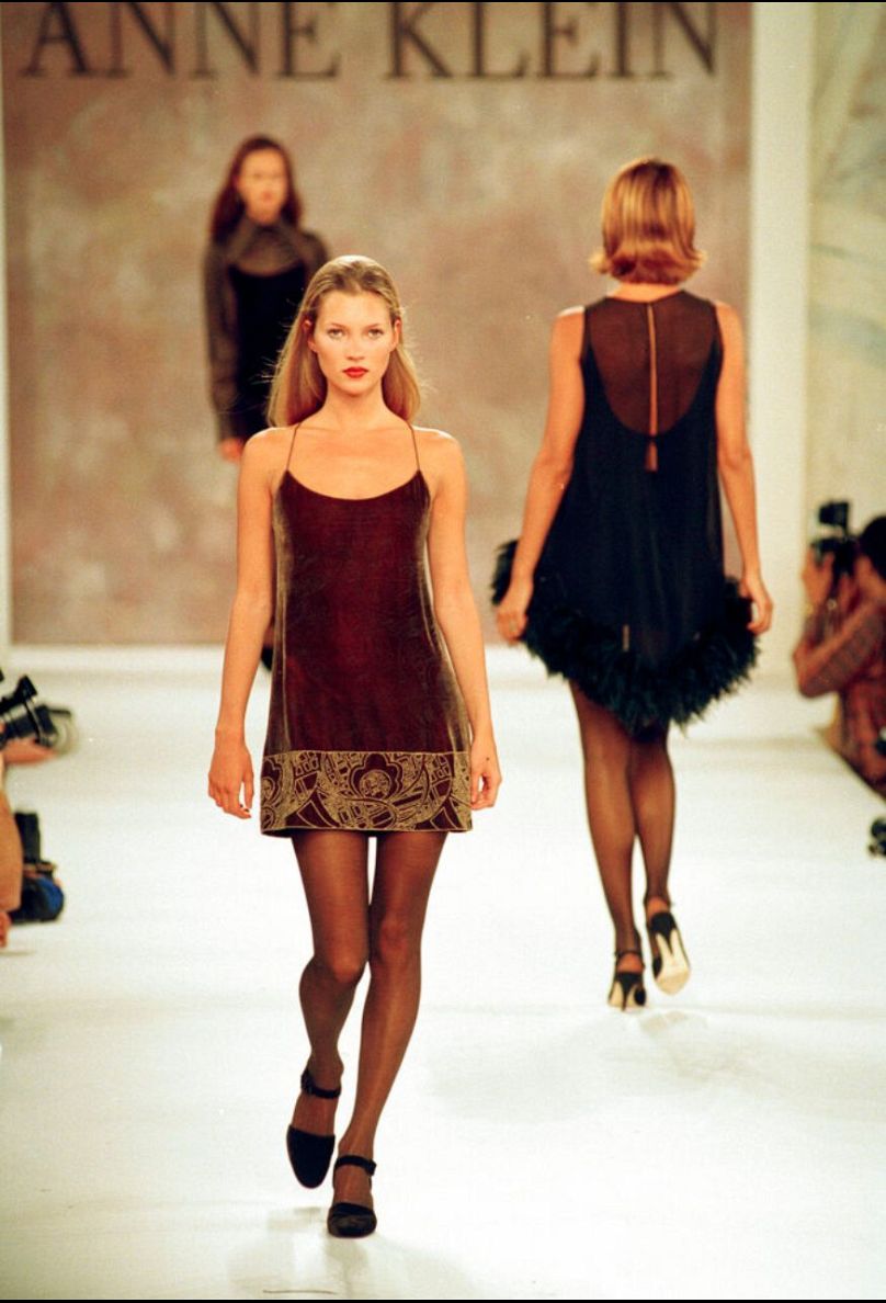 Kate Moss models a brown printed velvet slip dress during the showing of Anne Klein Fall 1994 by Richard Tyler in New York, 7 April 1994.