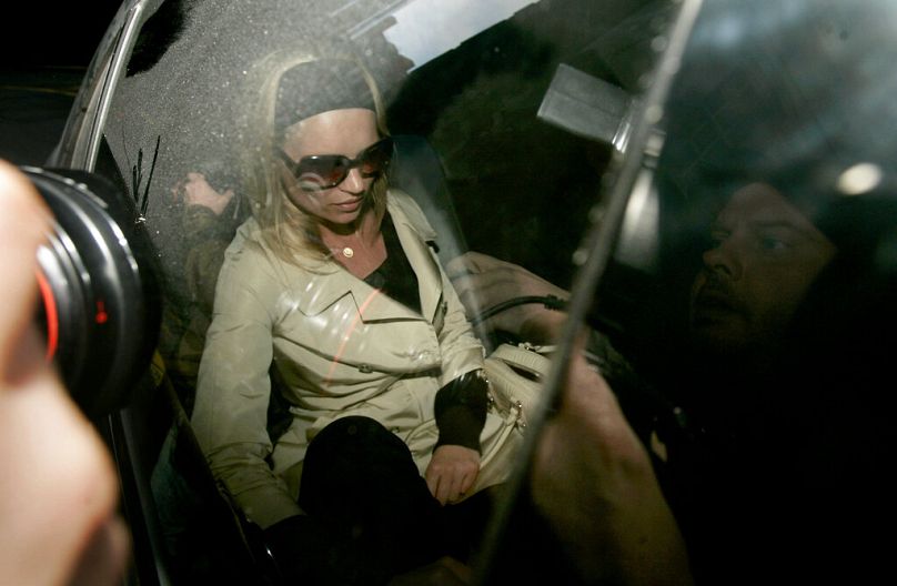 Kate Moss is driven away from a police station in London after being interviewed by detectives about her alleged cocaine use, 31 January 2006.