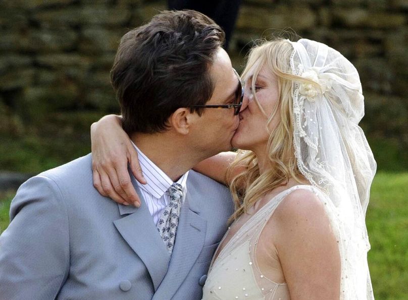 Kate Moss, right, and British guitarist Jamie Hince pose for photographers after their wedding in the village of Southrop, England, Friday, July 1, 2011.