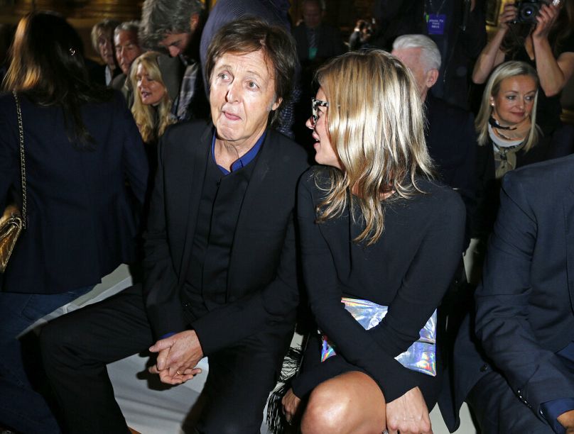Sir Paul McCartney and Moss, right, take their seats for the British fashion designer Stella McCartney's ready to wear Spring-Summer 2013 collection, 1 October 2012.