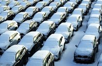 Snow covered vehicles sit in a rental car parking lot at the O'Hare International Airport in Chicago, Sunday, Jan. 14, 2024. 
