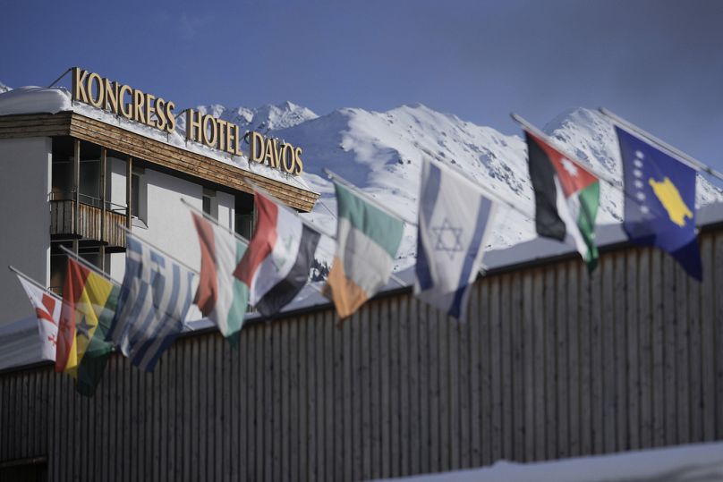 International flags wave on top of the Davos Congress Center where the World Economic Forum takes place in Davos, Switzerland, Monday, Jan. 15, 2024.