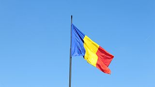 Romanian flag floating in the country's capital city, Bucharest.