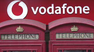 Phone boxes are placed in front of a Vodafone store in London, Wednesday, June 14, 2023. 