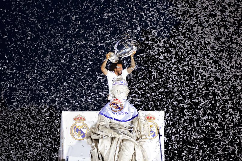 Real Madrid player Marcelo holds the Champions League trophy at Cibeles Square in front of the City Hall in Madrid, May 2022