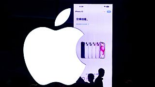 People silhouetted as they visit an Apple Store to try out the iPhone 15 handsets at an outdoor shopping mall in Beijing, Sunday, Sept. 24, 2023. (AP Photo/Andy Wong)