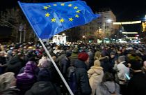 A protester waves an EU flag during a rally in downtown Belgrade, Serbia, Tuesday, Jan. 16, 2024. 