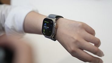 A person tries on an Apple Watch during an announcement of new products on the Apple campus.