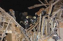 In this photo provided by Kharkiv Regional Administration, emergency workers work in an apartment house damaged in Russian rocket attack is seen in Kharkiv, Ukraine, in the ea