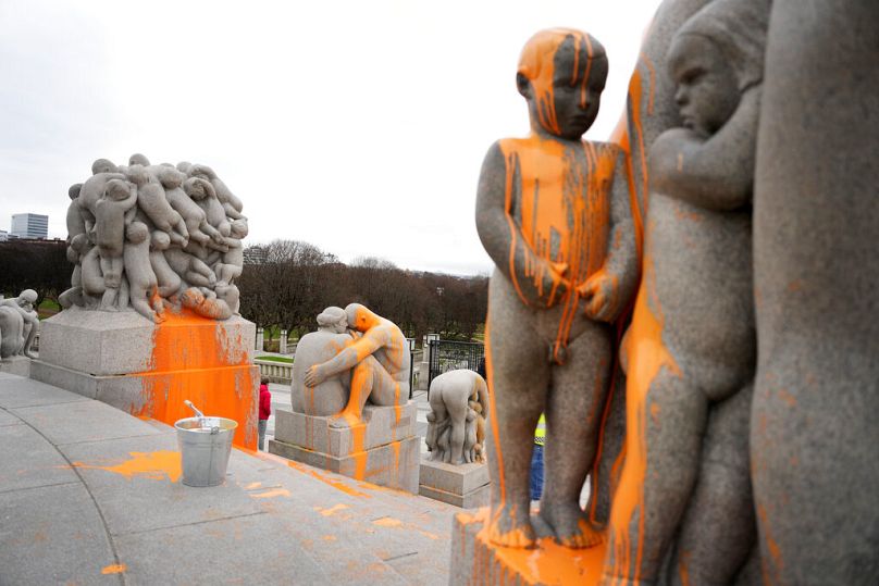 Sculptures are covered in orange paint after activists from Stopp oljeleting (Stop Oil Now) have spread paint over them in the Vigeland Sculpture Park in Oslo, November 2022