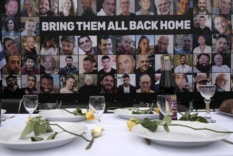 Pictures of hostages kidnapped during the Oct. 7 attack in Israel are placed by a table outside the International Court of Justice in The Hague, Netherlands, Jan. 12, 2024