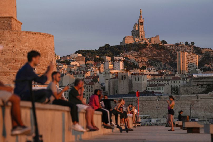 The Notre Dame de la Garde Basilica is seen on a top of the hill during a sunset in Marseille, September 2023