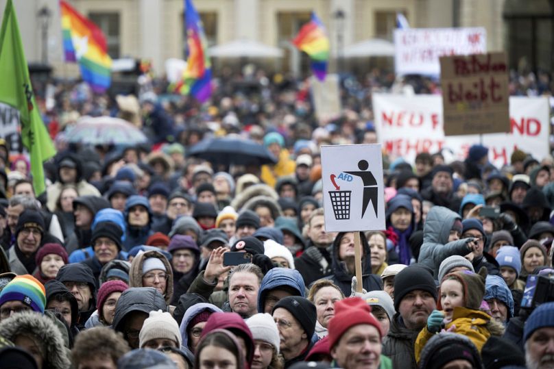 People stand on the Alter Markt square during the "Potsdam defends itself" demonstrations in Potsdam, near Berlin, Germany, Sunday, Jan. 14, 2024.