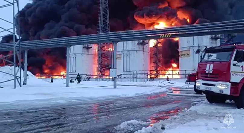 Russian Emergency Ministry employees work at the side of fire of oil reservoirs after the drone reached Klintsy, a city in Bryansk Region of Russia