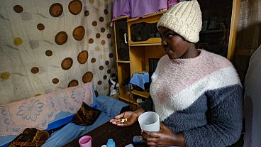 A teenager in Kenya takes her PEPFAR-supplied HIV medication in August 2023.