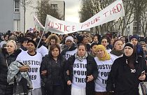 People march in the streets of Aulnay-sous-Bois, north of Paris, France, holding a sign reading "Justice for Theo" during a protest after an officer was charged with violence