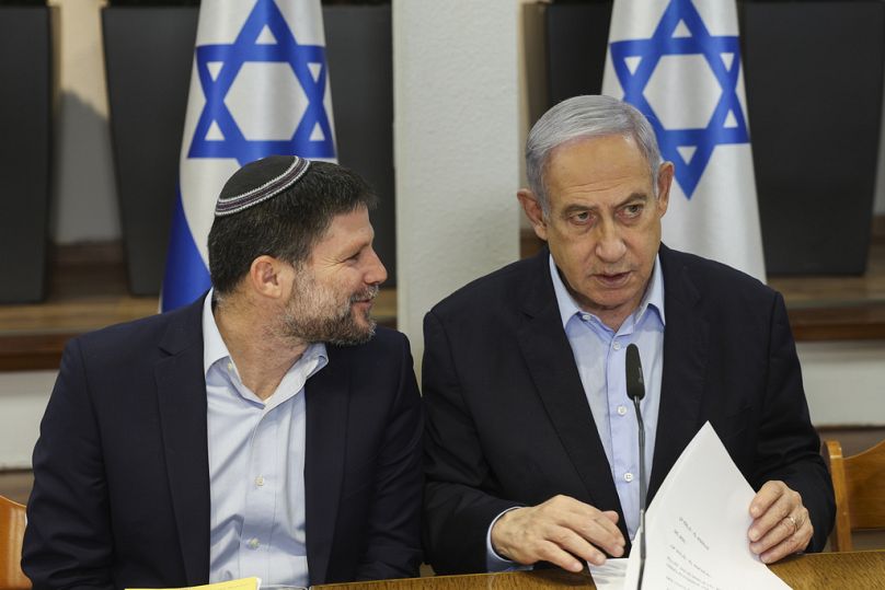 Israeli Prime Minister Benjamin Netanyahu, right, speaks with Minister of Finance Bezalel Smotrich during a cabinet meeting in Tel Aviv, Israel earlier in January