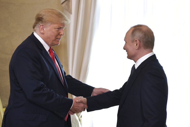 Former US President Donald Trump and Russian President Vladimir Putin, right, welcome each other at the Presidential Palace in Helsinki, Finland in 2018