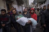 Mohammad Shouman carries the body of his daughter, Masa, who was killed in an Israeli bombardment of the Gaza Strip, during her funeral in Rafah, southern Gaza