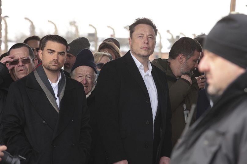 Tesla and SpaceX's CEO Elon Musk, centre, walks during his visit to the site of the Auschwitz-Birkenau Nazi German death camp in Oswiecim, Poland, on Monday, Jan. 22, 2024.