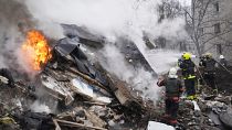 Rescuers work at the scene of a building damaged by a Russian rocket attack in Kharkiv.