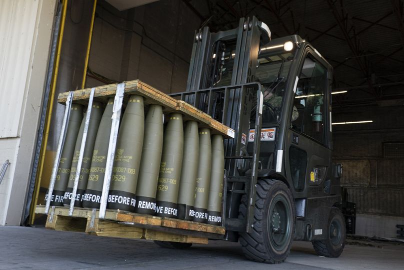 Airmen with the 436th Aerial Port Squadron use a forklift to move 155mm shells bound for Ukraine at Dover Air Force Base, Delaware.