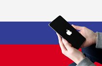 A montage depicting the Russian flag and an iPhone