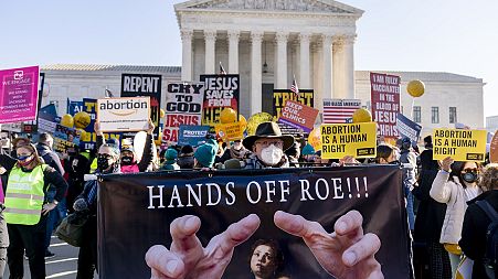 Abortion rights advocates and anti-abortion protesters demonstrate in front of the U.S. Supreme Court, Dec. 1, 2021, in Washington.