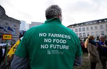 Un agriculteur porte une chemise avec un message lors d'une manifestation d'agriculteurs français et belges devant le Parlement européen à Bruxelles, mercredi 24 janvier 202.