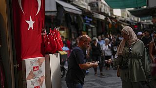 A seller talks to a customer in a street market in Istanbul, Turkey, on Sept. 6, 2023. 