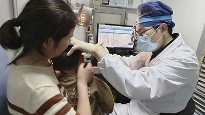 Dr Yilai Shu examines a young patient at the Eye & ENT Hospital of Fudan University in Shanghai, China, after a gene therapy procedure for hereditary deafness.