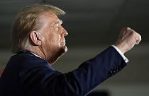 Republican presidential candidate former President Donald Trump gestures as he arrives at a campaign event in Laconia, N.H., Monday, Jan. 22, 2024. 