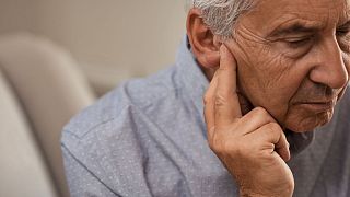 An older man with hearing problems.