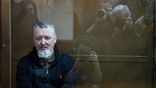 Igor Girkin sits in a glass cage in a courtroom at Moscow's City Court.