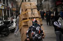 A man pulls a trolley with goods in Eminonu commercial area in Istanbul, Turkey, Thursday, Jan. 25, 2024.  